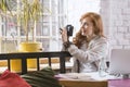 Female photographer in trendy cafe