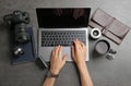 Female photographer using laptop at table