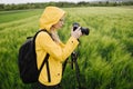 Female photographer using tripod and camera for shooting Royalty Free Stock Photo