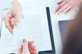 Female physician hand give white blank calling card to businesswoman closeup in office. Royalty Free Stock Photo