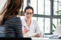 Female physician listening to her patient during consultation in Royalty Free Stock Photo