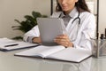 Female physician using tablet computer, giving online virtual consultation Royalty Free Stock Photo