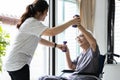 Female physiotherapist working or work out with a senior patient,old elderly exercising with dumbbells,asian caregiver assisting