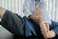 Female physiotherapists provide assistance to male patients with elbow injuries examine patients in rehabilitation centers. Royalty Free Stock Photo