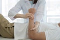 Female physiotherapists provide assistance to male patients with elbow injuries examine patients in rehabilitation centers. Royalty Free Stock Photo