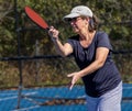 Female pickleball player executes forehand groundstroke