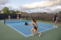 Female Pickleball Player Returns Ball