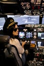 Female pilot the captain of the plane prepares for take-off in the plane cockpit. Royalty Free Stock Photo