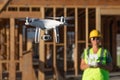 Female Pilot Flies Drone Quadcopter Inspecting Construction Site Royalty Free Stock Photo