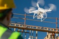 Female Pilot Flies Drone Quadcopter Inspecting Construction Site Royalty Free Stock Photo