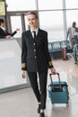 female pilot with suitcase walking Royalty Free Stock Photo