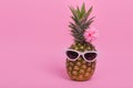 Female pineapple hipster in sunglasses with flower, stylish fruit, minimal concept Royalty Free Stock Photo