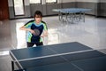 female pingpong athlete holding ball and paddle preparing to serve Royalty Free Stock Photo