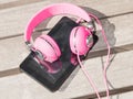 Female pink headphones and tablet pc