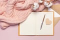 Female pink knitted sweater, cotton, open blank notebook, love letter on pastel pink background top view flat lay. Lady winter Clo