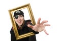 Female pirate in black coat holding photo frame Royalty Free Stock Photo