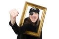 Female pirate in black coat holding photo frame Royalty Free Stock Photo