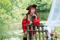 Female Pirate Girl with Red Bandanna on boat with pirate pistol Royalty Free Stock Photo