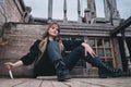 A female pirate sits with a knife on Board a ship. The knife in the girl`s hand is stuck in the wooden deck Royalty Free Stock Photo