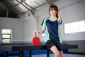 Female player holding red ping pong paddle with thumbs up Royalty Free Stock Photo