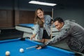 female player standing beside the male player while poking the white ball Royalty Free Stock Photo