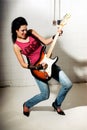 Female playing electric guitar Royalty Free Stock Photo