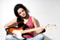 Female playing electric guitar Royalty Free Stock Photo