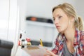 female plumber with clipboard looking at boiler Royalty Free Stock Photo