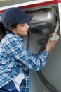 female plumber fitting siphon under kitchen sink Royalty Free Stock Photo