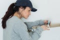 Female plumber fixing toilet flush Royalty Free Stock Photo