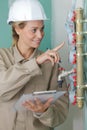 female plumber reading water meters Royalty Free Stock Photo