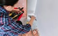 Female plumber tightening pipe with wrench in heating installation Royalty Free Stock Photo