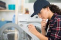 female plumber working on central heating boiler Royalty Free Stock Photo