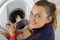 female plumber working on central heating boiler Royalty Free Stock Photo