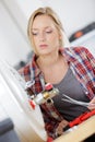 female plumber working on central heating boiler Royalty Free Stock Photo