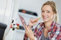 female plumber working on central heating boiler Royalty Free Stock Photo