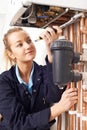 Female Plumber Working On Central Heating Boiler Royalty Free Stock Photo