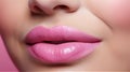 Female plump lips with pink lipstick gloss