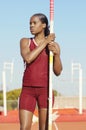 Female Pole Vaulter Holding Pole