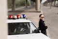 female police officer with crossed arms leaning Royalty Free Stock Photo