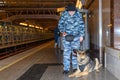 Female police officer with a trained german shepherd dog sniffs out drugs or bomb in luggage. Translations for non-English text: `