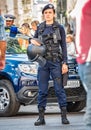 Female police officers and Gendarmerie or military police closely supervising the demonstrators