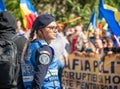 Female police officers and Gendarmerie or military police closely supervising the demonstrators