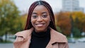 Female portrait close-up young satisfied happy african american woman standing in autumn park looking at camera smiling Royalty Free Stock Photo