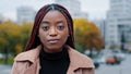 Female portrait close-up young serious pensive beautiful stylish african american woman standing outdoors looking at Royalty Free Stock Photo