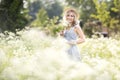 Female portrait outdoors. a woman in a straw hat in a flower field with a bouquet of wild flowers. Royalty Free Stock Photo