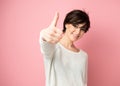 Female portrait with positive expressions and thumb up. Beautiful young woman happy and excited expressing winning gesture.
