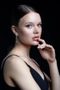 Female portrait with rhinestones makeup. Woman with earring in the form of a shiny ring in the ear