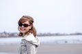 Female portrait on the Rocky shoreline along the Atlantic coast of Maine, near Portland, on an overcast spring day