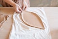 Female potter cuts clay pancake, pottery workshop Royalty Free Stock Photo